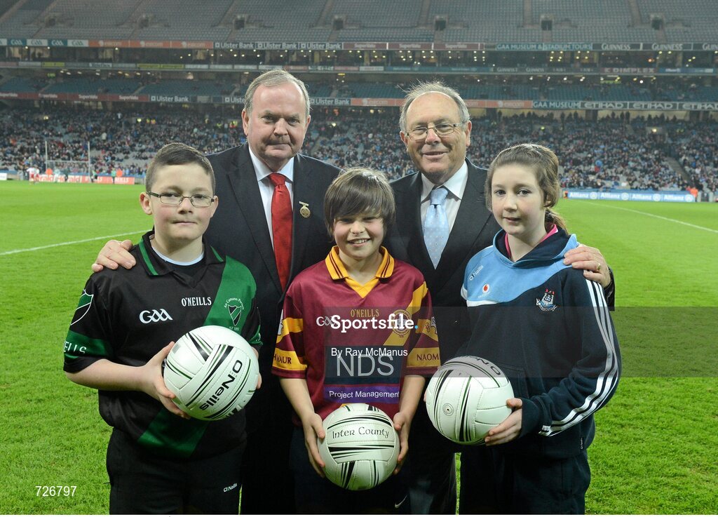 2 March 2013; Uachtarán Chumann Lúthchleas Gael Liam Ó Néill, in the company of Donal Bollard, Allianz Ireland,  makes a presentation to exceptional players from the Allianz Cumann na mBunscoil finals. The recipients are, left to right, Nathan Burke, aged 12, Scoil Fhursa, Kilmore West, Neil Rock, aged 12, Rush National School and Ciara Holland, aged 12, St Helen's Portmarnock. Allianz Football League, Division 1, Dublin v Mayo, Croke Park, Dublin. Picture credit: Ray McManus / SPORTSFILE
