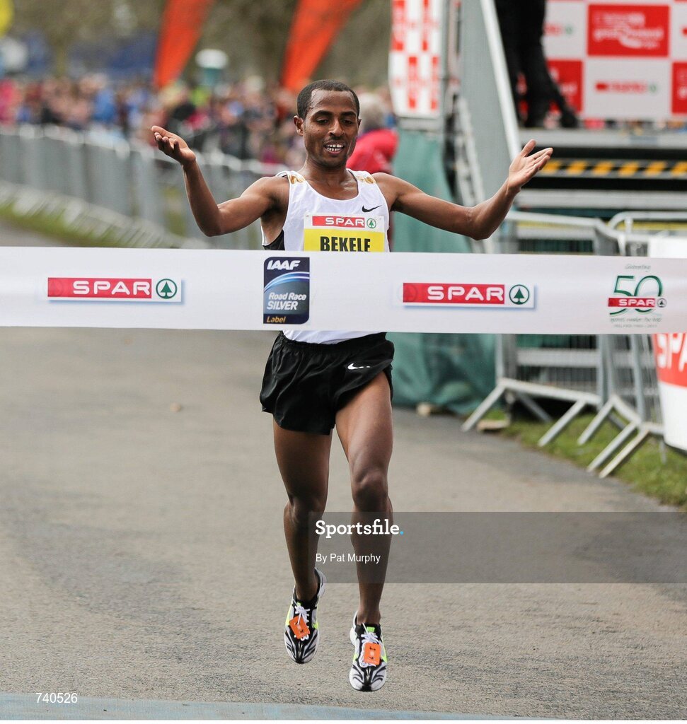 14 April 2013; Kenenisa Bekele, Ethiopia, crosses the finish line to win the SPAR Great Ireland Run 2013. Phoenix Park, Dublin. Picture credit: Pat Murphy / SPORTSFILE