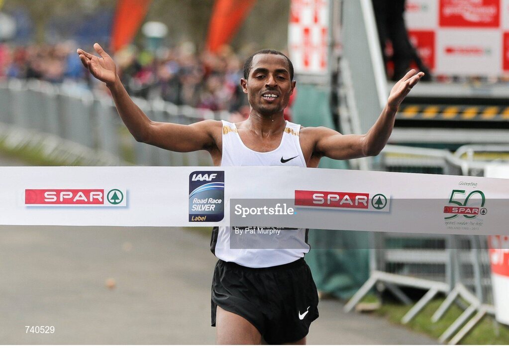 14 April 2013; Kenenisa Bekele, Ethiopia, crosses the finish line to win the SPAR Great Ireland Run 2013. Phoenix Park, Dublin. Picture credit: Pat Murphy / SPORTSFILE