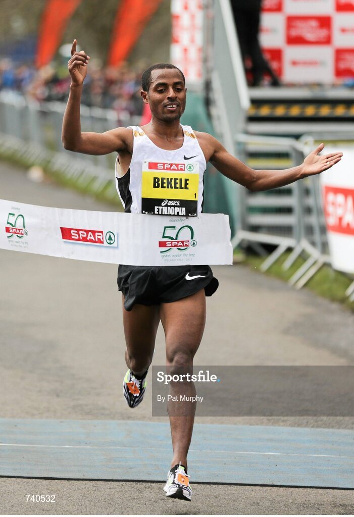 14 April 2013; Kenenisa Bekele, Ethiopia, crosses the finish line to win the SPAR Great Ireland Run 2013. Phoenix Park, Dublin. Picture credit: Pat Murphy / SPORTSFILE
