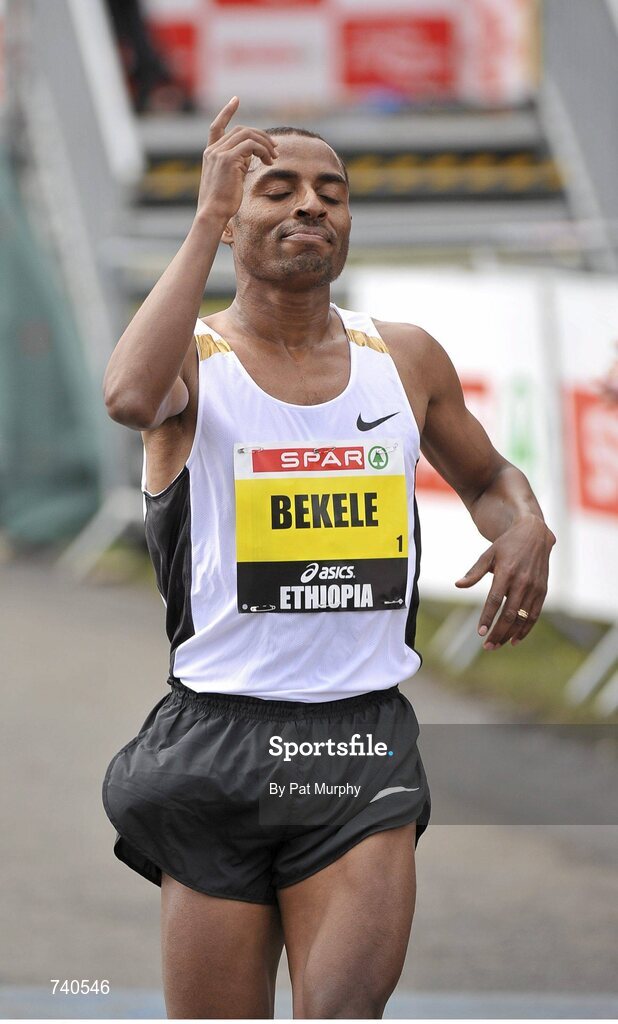 14 April 2013; Kenenisa Bekele, Ethiopia, crosses the finish line to win the SPAR Great Ireland Run 2013. Phoenix Park, Dublin. Picture credit: Pat Murphy / SPORTSFILE