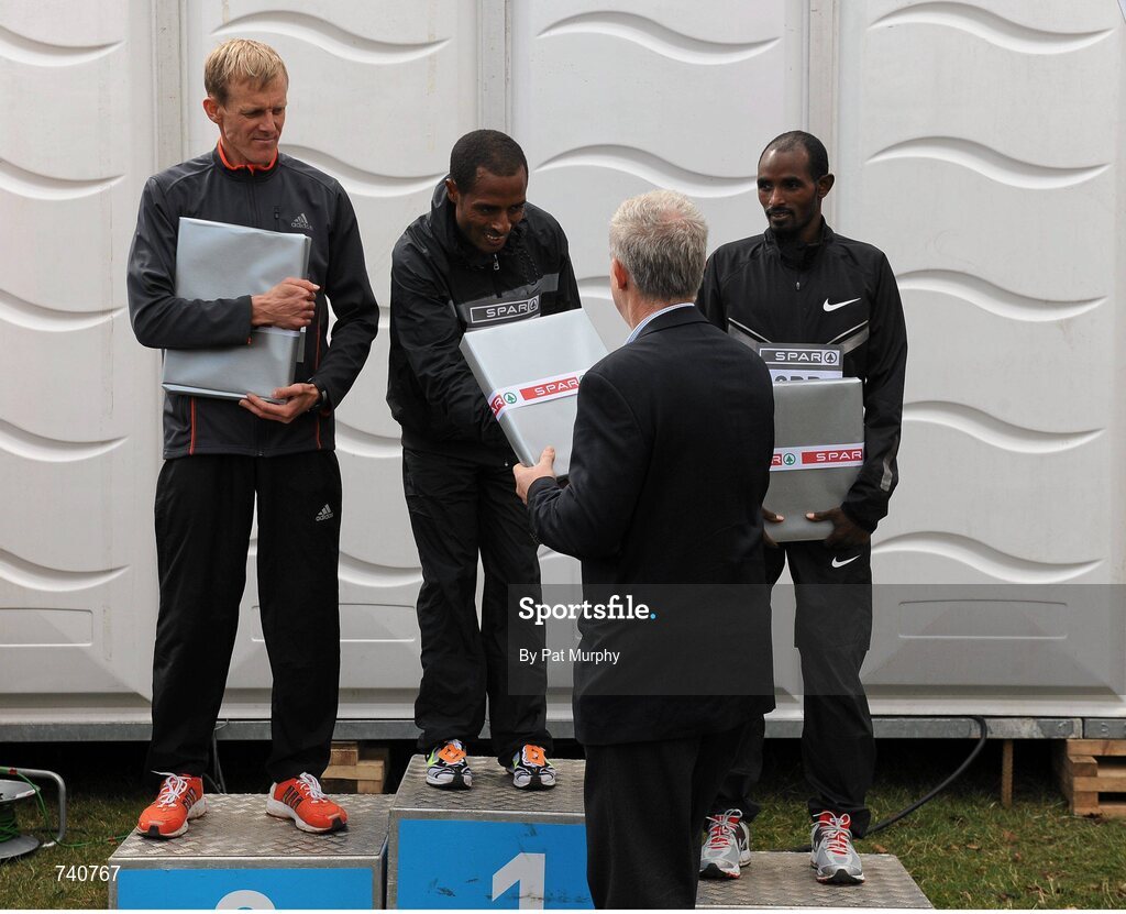 14 April 2013; Winner of the SPAR Great Ireland Run 2013 Kenenisa Bekele, Ethiopia, is presented with his prize by Willie O'Byrne, Managing Director of SPAR Ireland, alongside second placed Sergiy Lebid, Ukraine, left, third placed Ibrahim Jeilan, Ethiopia, right. Phoenix Park, Dublin. Picture credit: Pat Murphy / SPORTSFILE