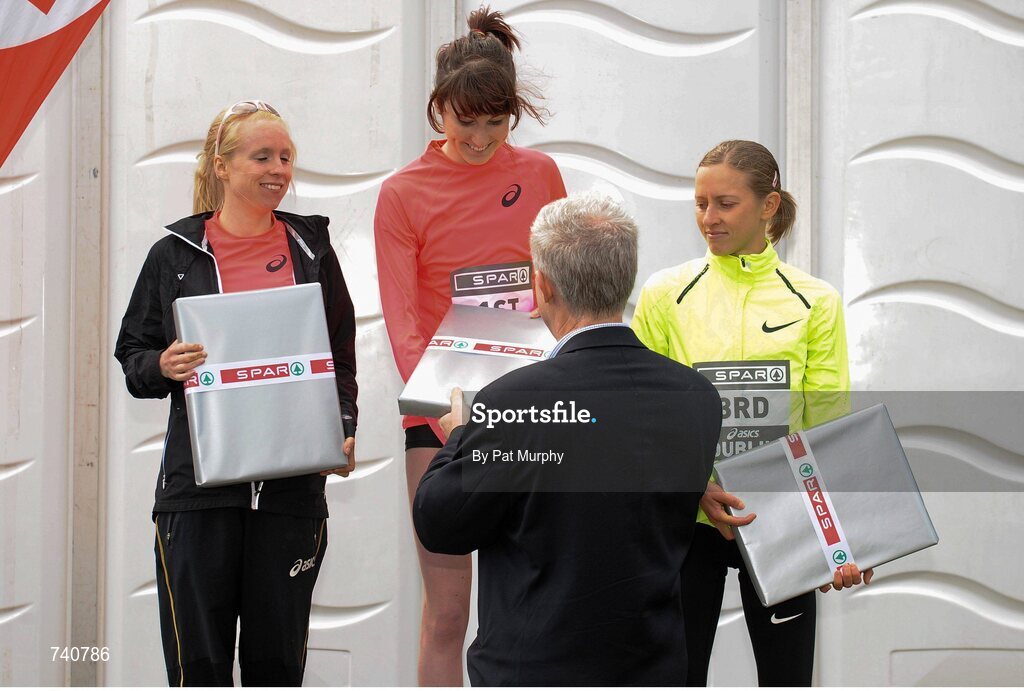 14 April 2013; Winner of the SPAR Great Ireland Run 2013 Women's race Lauren Howarth, Great Britain, is presented with her prize by Willie O'Byrne, Managing Director of SPAR Ireland alongside second placed Gemma Steel, Great Britain, left, and third placed Julia Bleasdale, Great Britain, right. Phoenix Park, Dublin. Picture credit: Pat Murphy / SPORTSFILE