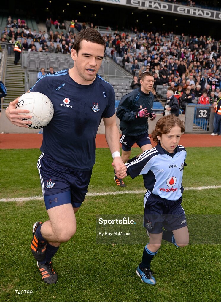 14 April 2013; Match day mascot Matthew Sherlock, Raheny, Co. Dublin, and Dublin's Ger Brennan as they run on to the pitch for the game. Allianz Football League, Division 1, Semi-Final, Dublin v Mayo, Croke Park, Dublin. Picture credit: Ray McManus / SPORTSFILE