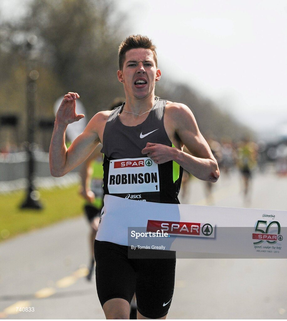 14 April 2013; Paul Robinson, St. Coca's A.C, crosses the line to win the Elite Men's Mile event at the SPAR Great Ireland Run 2013. Phoenix Park, Dublin. Picture credit: Tomás Greally / SPORTSFILE