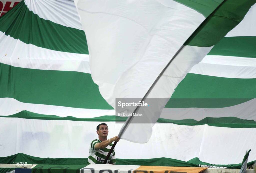 13 June 2003; A Shamrock Rovers supporters waves a flag during the Eircom League Premier Division match between Shamrock Rovers and St Patrick's Athletic at Richmond Park in Dublin. Photo by David Maher/Sportsfile