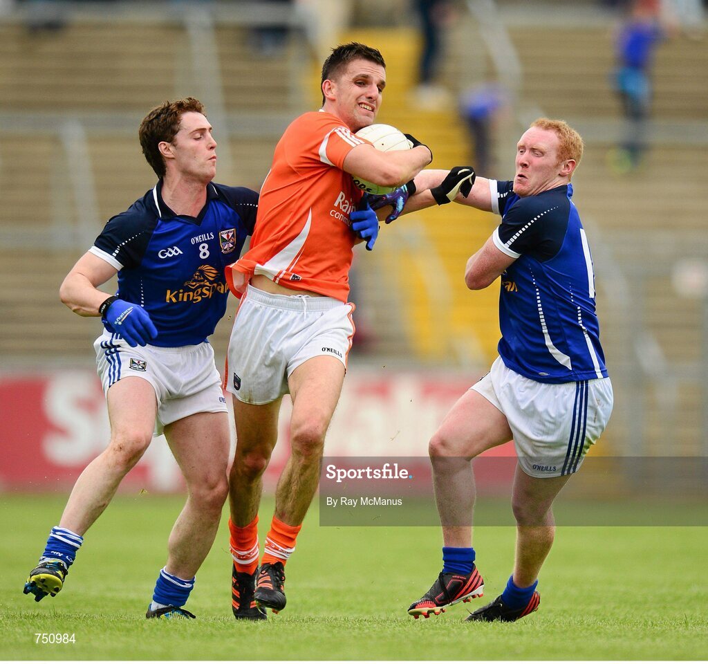 19 May 2013; Stephen Harold, Armagh, is tackled by Damien O'Reilly, left, and Cian Mackey, Cavan. Ulster GAA Football Senior Championship, Preliminary Round, Cavan v Armagh, Kingspan Breffni Park, Cavan. Picture credit: Ray McManus / SPORTSFILE