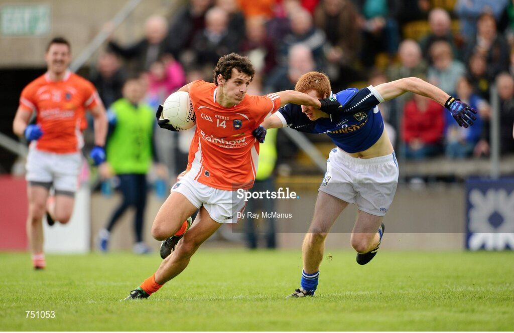 19 May 2013; Jamie Clarke, Armagh, has his jersey pulled by Cavan corner back Jason McLoughlin as he bursts through to score a goal for Armagh, which was subsequently disallowed in favour of a free. Ulster GAA Football Senior Championship, Preliminary Round, Cavan v Armagh, Kingspan Breffni Park, Cavan. Picture credit: Ray McManus / SPORTSFILE