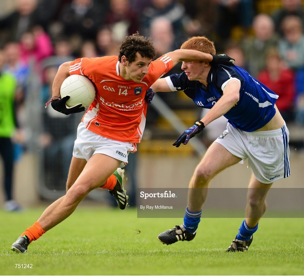 19 May 2013; Jamie Clarke, Armagh, has his jersey pulled by Cavan corner back Jason McLoughlin as he bursts through to score a goal for Armagh, which was subsequently disallowed in favour of a free. Ulster GAA Football Senior Championship, Preliminary Round, Cavan v Armagh, Kingspan Breffni Park, Cavan. Picture credit: Ray McManus / SPORTSFILE
