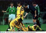 30 April 1997; Republic of Ireland's Roy Keane pleads innocence as Romania's Viorel Moldovan lies injured watches by referee Mario Van Der Ende. World Cup Qualifier, Romania v Republic of Ireland, Bucharest, Romania. Soccer. Picture credit; David Maher/SPORTSFILE