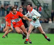 29 June 1997; Adrian Cush of Tyrone in action against Karl Diamond of Derry during the Ulster GAA Football Senior Championship Semi-Final match between Tyrone and Derry at St. Tiernach's Park, Clones, Monaghan. Photo by David Maher/Sportsfile