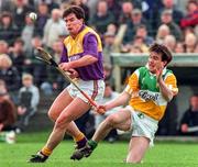 23 March 1997; Adrian Fenlon of Wexford in action against Johnny Pilkington of Offaly during the National Hurling League Division 1 match between Offaly and Wexford at St. Brendan's Park in Birr, Offaly. Photo by David Maher/Sportsfile
