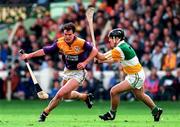 22 June 1997; Adrian Fenlon of Wexford in action against Colm Cassidy of Offaly during the GAA Leinster Senior Hurling Championship Semi-Final match between Wexford and Offaly at Croke Park in Dublin. Photo by Ray McManus/Sportsfile