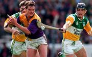 22 June 1997; Adrian Fenlon of Wexford in action against Colm Cassidy, right, and Martin Hanamy of Offaly during the GAA Leinster Senior Hurling Championship Semi-Final match between Wexford and Offaly at Croke Park in Dublin. Photo by Ray McManus/Sportsfile