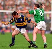 15 June 1997; Aidan Butler of Tipperary in action against Mike Houlihan of Limerick during the Munster GAA Senior Hurling Championship Semi-Final match between Tipperary and Limerick at Semple Stadium, Thurles. Photo by Ray McManus/Sportsfile