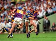 17 August 1997; Brian O'Meara of Tipperary in action against Colm Kehoe and Eugene Furlong, 4, of Wexford during the GAA All-Ireland Senior Hurling Championship Semi-Final match between Tipperary and Wexford at Croke Park in Dublin. Photo by Ray McManus/Sportsfile