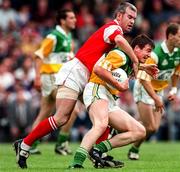 29 June 1997; Ciaran McManus of Offaly is tackled by David Reilly of Louth during the Leinster GAA Senior Football Championship Semi-Final match between Offaly and Louth at Páirc Tailteann in Navan, Co Meath. Photo by Ray McManus/Sportsfile