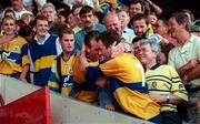 14 September 1997; Clare's Ollie Baker has a word with captain Anthony Daly as Daly goes up the steps to collect the trophy following Clare's victory in the Guinness All Ireland Hurling Final match between Clare and Tipperary at Croke Park in Dublin. Photo by Ray McManus/Sportsfile