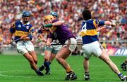 17 August 1997; Garry Laffan of Wexford in action against, from left, Colm Bonner, Noel Sheehy and Michael Ryan, 4, of Tipperary during the GAA All-Ireland Senior Hurling Championship Semi-Final match between Tipperary and Wexford at Croke Park in Dublin. Photo by David Maher/Sportsfile