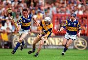 14 September 1997; Ger O'Loughlin of Clare in action against Aiden Butker, left, and John Leahy of Tipperary during the Guinness All Ireland Hurling Final match between Clare and Tipperary at Croke Park in Dublin. Photo by Ray McManus/Sportsfile