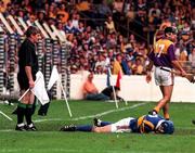 17 August 1997; Linesman Pat Horan lookes on as John Leahy of Tipperary lays on the ground after a clash with John O'Connor of Wexford during the GAA All-Ireland Senior Hurling Championship Semi-Final match between Tipperary and Wexford at Croke Park in Dublin. Photo by David Maher/Sportsfile