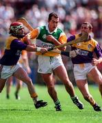 22 June 1997; Johnny Dooley of Offaly in action against Sean Flood, left, with, Larry O'Gorman of Wexford during the GAA Leinster Senior Hurling Championship Semi-Final match between Wexford and Offaly at Croke Park in Dublin. Photo by Ray McManus/Sportsfile