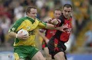 26 July 2003; Both captains Adrian Sweeney, Donegal, in action against Down's Sean Ward. Bank of Ireland Senior Football Championship qualifier, Down v Donegal, St. Tighernach's Park, Clones, Co Monaghan. Picture credit; Ray McManus / SPORTSFILE *EDI*