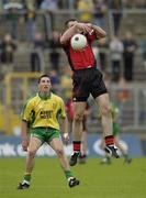 26 July 2003; Sean Ward, Down, in action against Donegal's Michael Hegarty. Bank of Ireland Senior Football Championship qualifier, Down v Donegal, St. Tighernach's Park, Clones, Co Monaghan. Picture credit; Ray McManus / SPORTSFILE *EDI*