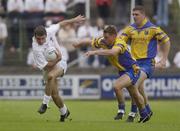 26 July 2003; Patrick Murray of Kildare in action against Paul Noone, centre, and Seamus O'Neill of Roscommon during the Bank of Ireland Senior Football Championship Qualifier between Kildare and Roscommon at O'Moore Park in Portlaoise, Laois. Photo by Damien Eagers/Sportsfile