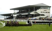 28 July 2003; A general view of runners and riders as they clear the 4th hurdle during the first race of the day, the G.P.T. Sligo Novice Hurdle, during the Galway Racing Festival at Ballybrit racecourse in Galway. Photo by Brendan Moran/Sportsfile