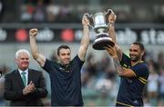 18 November 2017; Australian manager Chris Scott, left, and captain Shaun Burgoyne lift Cormac McAnallen Cup as Uachtarán Chumann Lúthchleas Gael Aogán Ó Fearghail looks on after the Virgin Australia International Rules Series 2nd test at the Domain Stadium in Perth, Australia.