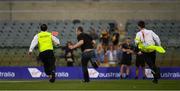 18 November 2017; A man who ran on to the pitch after the game is pursued by security personnel after the Virgin Australia International Rules Series 2nd test at the Domain Stadium in Perth, Australia. Photo by Ray McManus/Sportsfile