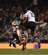 18 November 2017; Chris Farrell of Ireland is tackled by Ben Volavola, right, and Dominiko Waqaniburotu of Fiji, behind, during the Guinness Series International match between Ireland and Fiji at the Aviva Stadium in Dublin. Photo by Seb Daly/Sportsfile