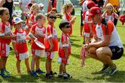 10 December 2017; Matthew O'Hanlon of Wexford presents three and a half year old Natham Ng with his medal afterat the coaching session and end of season medal presentations at the Singapore Gaelic Lions GAA training session at The Grandstand, Turf Club Rd, Bukit Timah, Singapore  Photo by Ray McManus/Sportsfile
