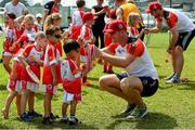 10 December 2017; Matthew O'Hanlon of Wexford presents three and a half year old Natham Ng with his medal afterat the coaching session and end of season medal presentations at the Singapore Gaelic Lions GAA training session at The Grandstand, Turf Club Rd, Bukit Timah, Singapore  Photo by Ray McManus/Sportsfile