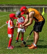 10 December 2017;  Richie Hogan of Kilkenny with Anna Mcnamara, four years and Cameron Kernaghan, 4 1/2 years, during a coaching session and end of season medal presentations at the Singapore Gaelic Lions GAA training session at The Grandstand, Turf Club Rd, Bukit Timah, Singapore  Photo by Ray McManus/Sportsfile