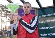 27 December 2017; Jockey Mark Walsh raises the trophy after he rode Simply Ned to victory in the Paddy's Rewards Club Steeplechase (Grade 1) on day 2 of the Leopardstown Christmas Festival at Leopardstown in Dublin. Photo by Barry Cregg/Sportsfile