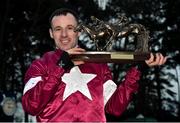 28 December 2017; Jockey Sean Flanagan poses with the trophy after winning the Leopardstown Christmas Steeplechase on Road To Respect during day 3 of the Leopardstown Christmas Festival at Leopardstown in Dublin. Photo by Seb Daly/Sportsfile