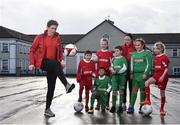 16 January 2018; The SPAR FAI Primary School 5s Programme was launched with a pop up training session at Scoil Mhuire CBS, Dublin, where former Republic of Ireland footballer and past pupil, Keith Andrews and current Republic of Ireland women's footballer, Megan Campbell provided a coaching masterclass to students from Scoil Mhuire CBS and St Vincent de Paul’s Girls NS. The five-a-side school blitzes are open to boys and girls from 4th, 5th and 6th class, and puts emphasis on fun and inclusivity. Register for the SPAR5s by February 9th at www.fai.ie/primary5. Pictured is former Republic of Ireland footballer and past pupil of Scoil Mhuire CBS, Keith Andrews, left, as he shows of his skills, to current pupils of Scoil Mhuire CBS and St Vincent de Paul’s Girls NS, at Scoil Mhuire CBS, Clontarf, Dublin. Photo by Seb Daly/Sportsfile