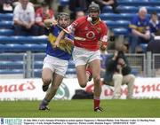 31 July 2003; Cork's Setanta O'hAilpin in action against Tipperary's Michael Phelan. Erin Munster Under 21 Hurling Final, Tipperary v Cork, Semple Stadium, Co. Tipperary. Picture credit; Damien Eagers / SPORTSFILE *EDI*