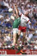 3 August 2003; Kevin Hughes, Tyrone, in action against Fermanagh's Paul Brewster. Bank of Ireland All-Ireland Senior Football Championship Quarter Final, Tyrone v Fermanagh, Croke Park, Dublin. Picture credit; Brendan Moran / SPORTSFILE *EDI*