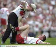 3 August 2003; Tyrone's Brian McGuigan has his leg stretched for cramp. Bank of Ireland All-Ireland Senior Football Championship Quarter Final, Tyrone v Fermanagh, Croke Park, Dublin. Picture credit; Damien Eagers / SPORTSFILE *EDI*