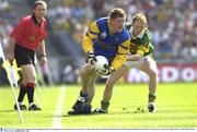 4 August 2003; Shane Curran of Roscommon prepares to clear under pressure from Colm Cooper of Kerry during the Bank of Ireland All-Ireland Senior Football Championship Quarter Final between Kerry and Roscommon at Croke Park in Dublin. Photo by Ray McManus/Sportsfile