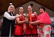28 January 2018; Fr Mathews co-captains Kellie Cahalane, 2nd left, and Amanda O'Regan are presented with the cup by Breda Dick, left, WNLC Member and President of Basketball Ireland Theresa Walsh during the Hula Hoops Senior Women's Cup Final match between Fr Mathews and Meteors at the National Basketball Arena in Tallaght, Dublin. Photo by Brendan Moran/Sportsfile