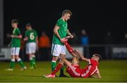 20 February 2018; Liam Doherty of Wales is helped by Luke Nolan of Republic of Ireland during the Under 18 International Friendly match between Republic of Ireland and Wales at Tramore AFC in Tramore, Co Waterford. Photo by Diarmuid Greene/Sportsfile
