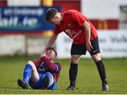 24 February 2018; David Walsh of University College Cork, right, helps Dylan Connolly of Dublin University AFC following a collision during the IUFU Harding Cup match between University College Cork and Dublin University AFC at Tolka Park in Dublin. Photo by Seb Daly/Sportsfile