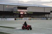 27 February 2018; A member of the Oriel Park ground staff clears snow from the pitch prior to the SSE Airtricity League Premier Division match between Dundalk and Limerick at Oriel Park in Dundalk, Co Louth. Photo by Stephen McCarthy/Sportsfile