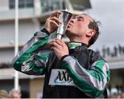 14 March 2018; Jockey Nico de Boinville celebrates with the trophy after winning the Betway Queen Mother Champion Steeple Chase on Altior on Day Two of the Cheltenham Racing Festival at Prestbury Park in Cheltenham, England. Photo by Seb Daly/Sportsfile