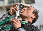 14 March 2018; Jockey Nico de Boinville celebrates with the trophy after winning the Betway Queen Mother Champion Steeple Chase on Altior on Day Two of the Cheltenham Racing Festival at Prestbury Park in Cheltenham, England. Photo by Seb Daly/Sportsfile
