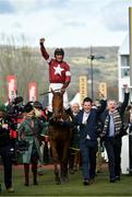 15 March 2018; Jockey Davy Russell celebrates as he enters the winners' enclosure with the groom, owner Michael O'Leary, right, and his wife Anita after winning the Ryanair Steeple Chase on Balko Des Flos on Day Three of the Cheltenham Racing Festival at Prestbury Park in Cheltenham, England. Photo by Ramsey Cardy/Sportsfile